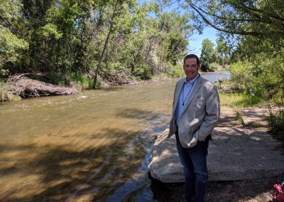 Sean Cronin, director of the St. Vrain and Left Hand Water Conservancy District stands beside the river