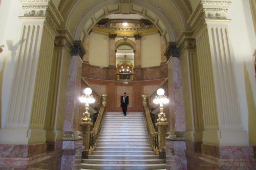 A man descends the main staircase at the Colorado State Capitol at the end of the work day on Feb. 19, 2019. Credit: Jerd Smith