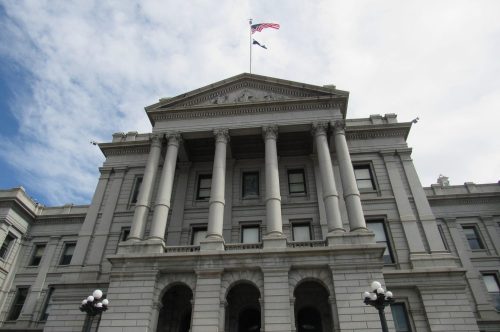 An American flag flies above the Colorado State Capitol. Credit: Jerd Smith