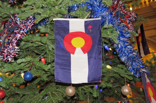 A holiday tree is adorned with the Colorado State flag at the State Capitol. Dec. 10, 2019. Credit: Jerd Smith