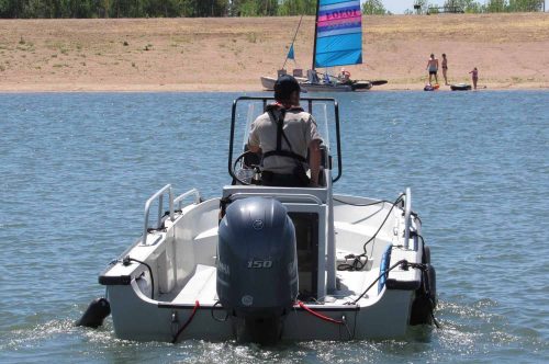 A Colorado Parks and Wildlife officer heads out on patrol at Chatfield Reservoir. A $171 million redesign at the popular lake is now complete, providing more water storage for Front Range cities and farmers. Last week the Colorado Water Conservation Board approved a settlement that will pave the way for an environmental water plan to help offset the impacts of the new storage. Credit: Jerd Smith